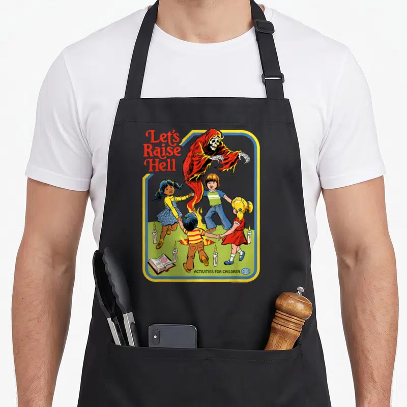 Rhode ghost apron - Grim Reaper above four children holding hands around candles and a book with Let's Raise Hell text — shown on a black cotton canvas apron against a white background