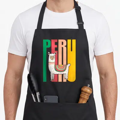Peru alpaca apron - Cartoon llama in front of green red peach and yellow PERU block letters — shown on a black cotton canvas apron against a white background