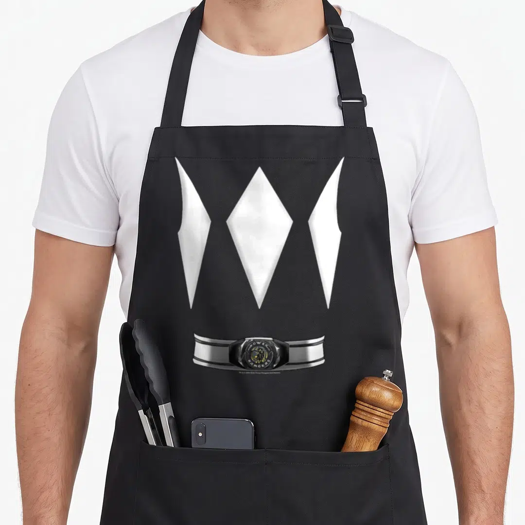 Funny hobby halloween apron - Three white diamonds above a silver and black Power Rangers belt with printed text — shown on a black cotton canvas apron against a white background
