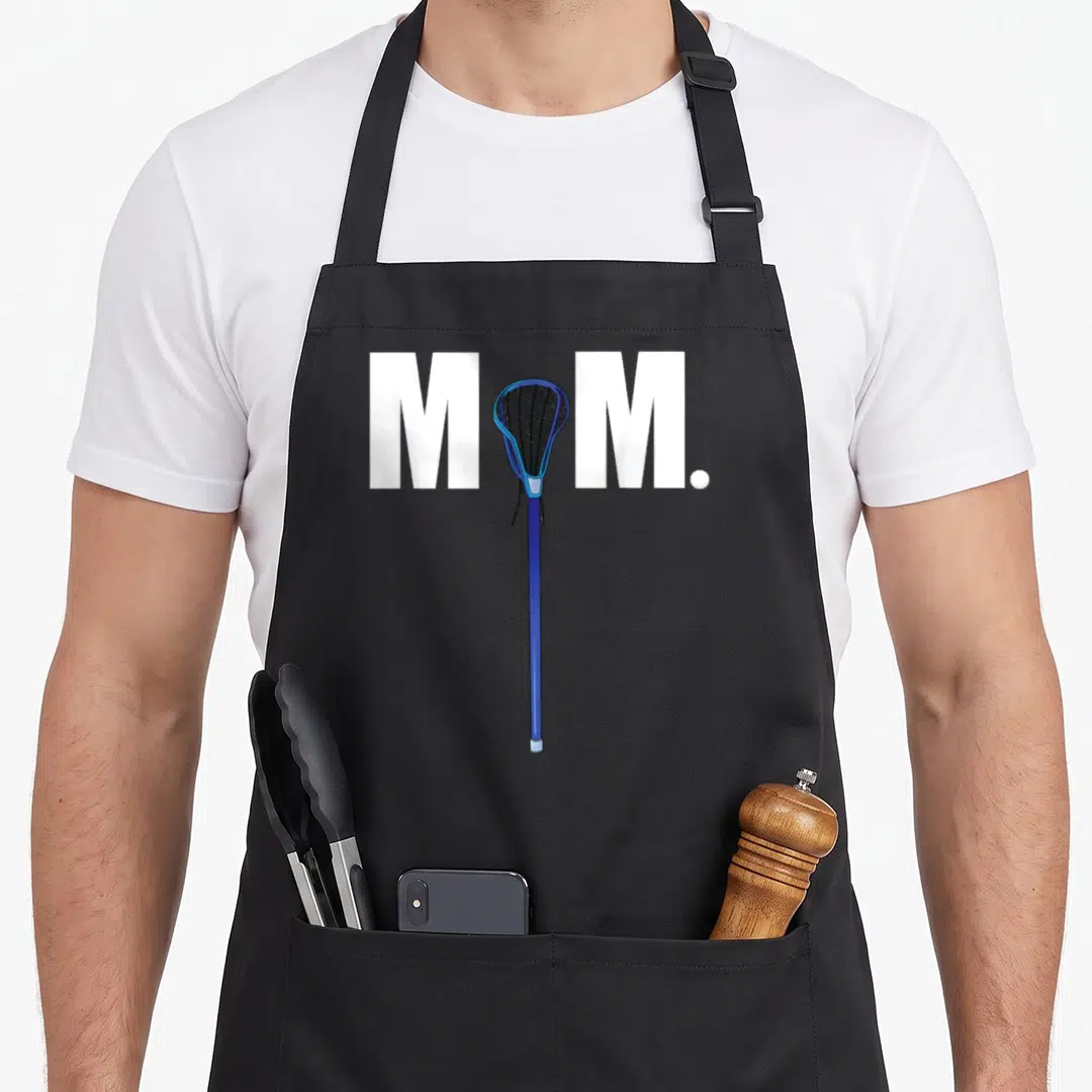 Funny lax lacrosse mom apron - White M M letters with blue lacrosse stick and white ball — shown on a black cotton canvas apron against a white background