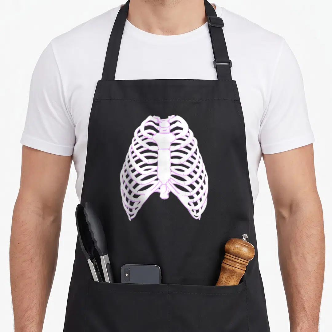 Bone goth apron - Cartoon white and light purple rib cage centered on apron front — shown on a black cotton canvas apron against a white background