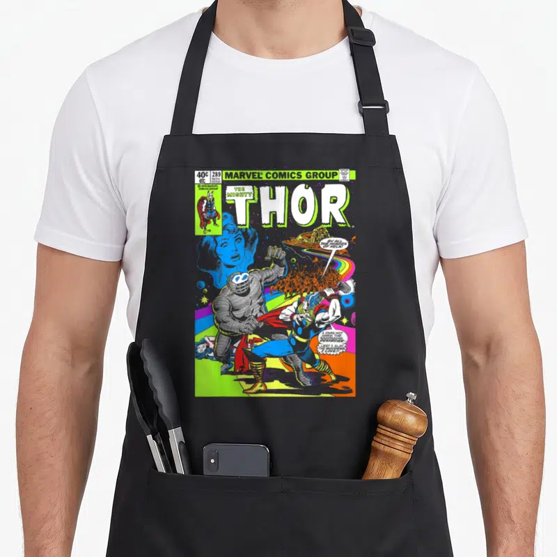 Neon hobby apron - Thor fighting Destroyer comic cover with lime green title and speech bubbles — shown on a black cotton canvas apron against a white background
