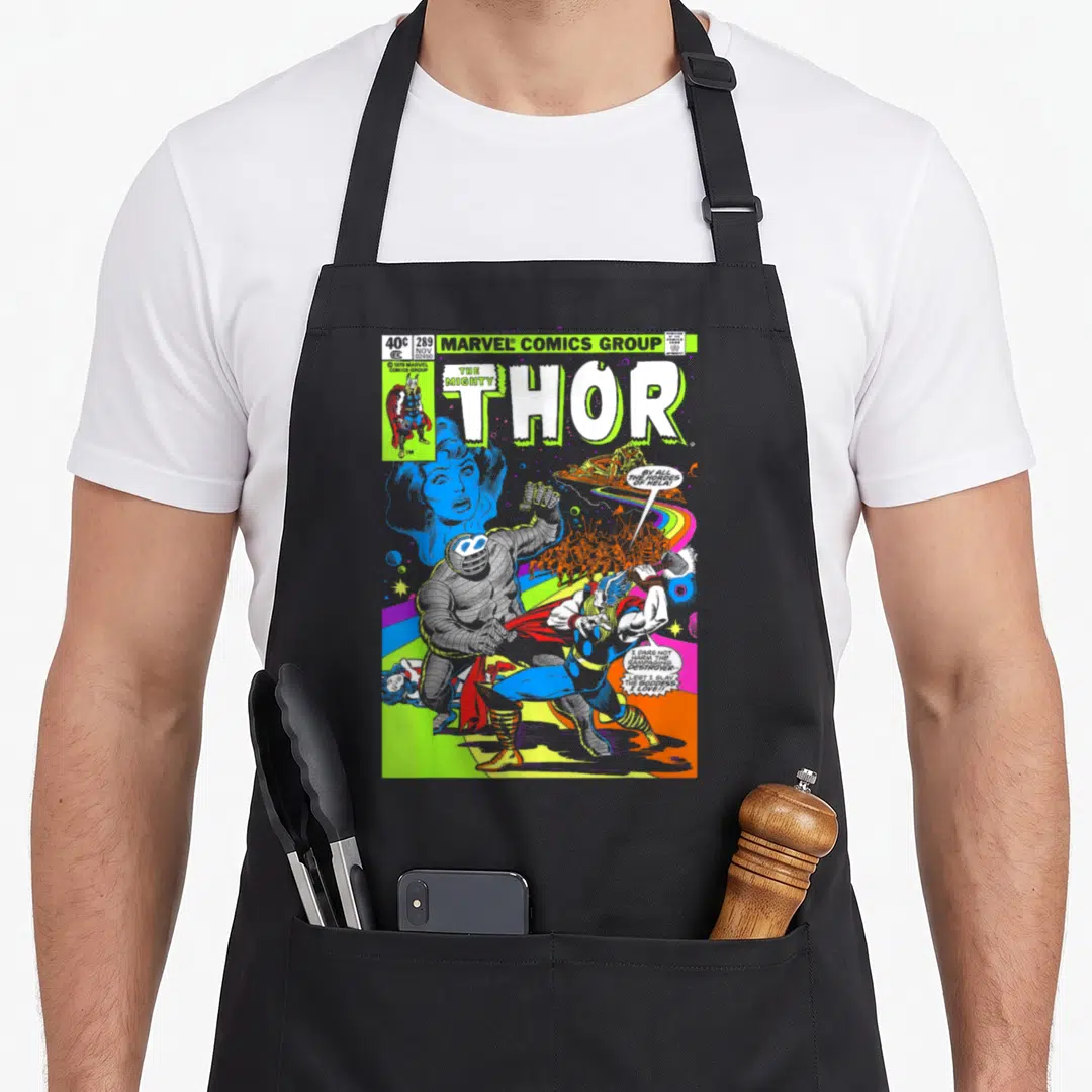 Neon hobby apron - Thor fighting Destroyer comic cover with lime green title and speech bubbles — shown on a black cotton canvas apron against a white background