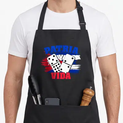 Patria libra girl apron - PATRIA Y VIDA text over two dominoes and distressed Cuban flag in blue white red — shown on a black cotton canvas apron against a white background