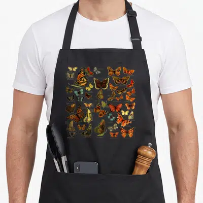 Entomology butterfly apron - Vintage illustration of 25 labeled butterflies and moths including Mourning Cloak, Red — shown on a black cotton canvas apron against a white background