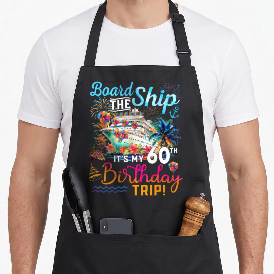 Board 60th birthday apron - Watercolor cruise ship with palm trees balloons and stacked text reading Board the Ship — shown on a black cotton canvas apron against a white background