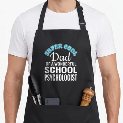 Psychologist school dad apron - Stacked white and blue text reading SUPER COOL Dad OF A WONDERFUL SCHOOL PSYCHOLOGIST — shown on a black cotton canvas apron against a white background