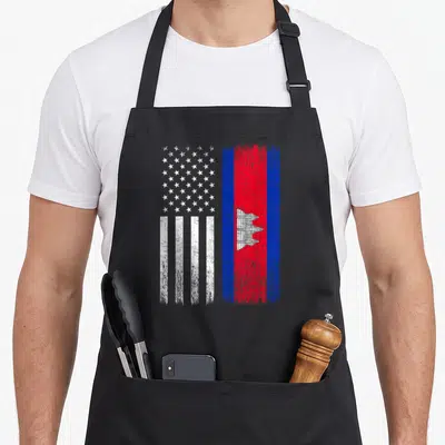 Cambodian american flag apron - Distressed USA and Cambodia flags side by side in white red and blue — shown on a black cotton canvas apron against a white background