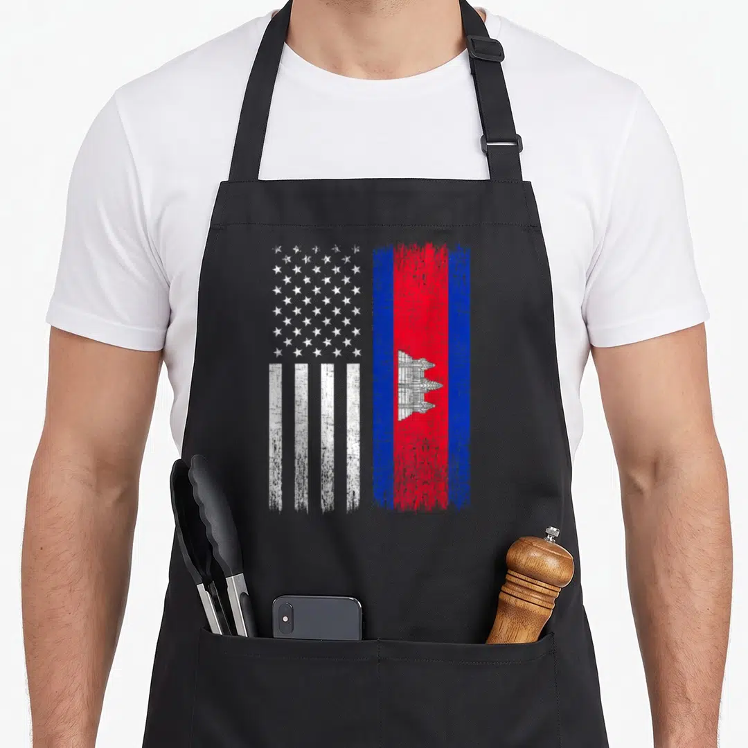 Cambodian american flag apron - Distressed USA and Cambodia flags side by side in white red and blue — shown on a black cotton canvas apron against a white background
