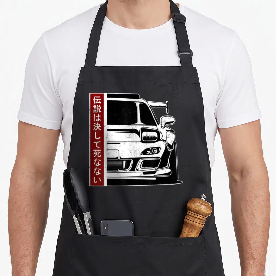 Legend japan apron - Distressed black and white car with red vertical banner containing Japanese characters — shown on a black cotton canvas apron against a white background