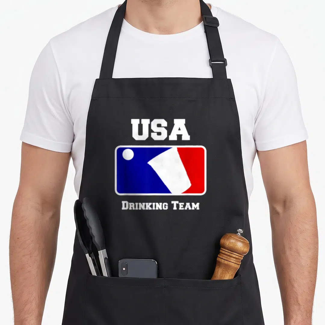 Drinking beer pong apron - USA logo with red white blue rectangle and DRINKING TEAM text below — shown on a black cotton canvas apron against a white background