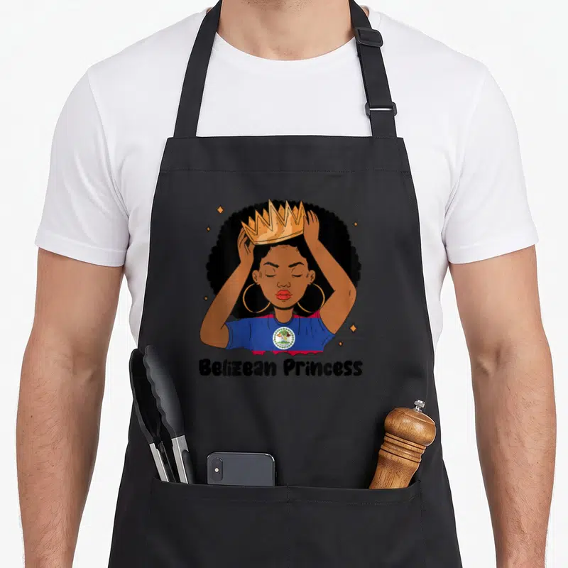 Belizean princess apron - Cartoon woman in gold crown and flag shirt with Belizean Princess text and stars — shown on a black cotton canvas apron against a white background