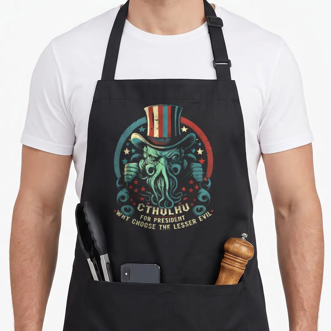 President horror apron - Cthulhu wearing striped top hat inside circle with stars and text CTHULHU FOR PRESIDENT WHY — shown on a black cotton canvas apron against a white background
