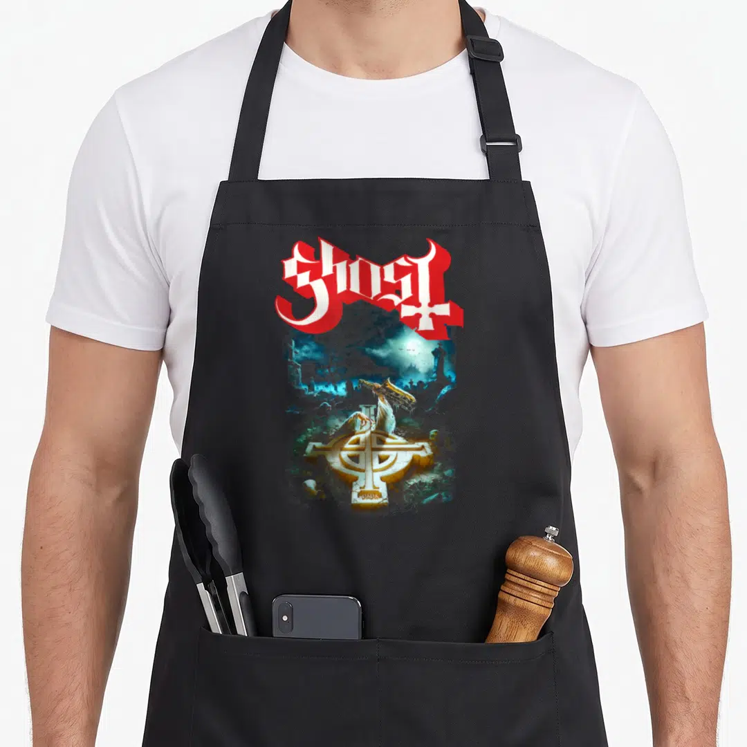 Rite ghost apron - Celtic cross with dragon perched on stone in graveyard, GHOST and PAPA text in red white gold blue — shown on a black cotton canvas apron against a white background
