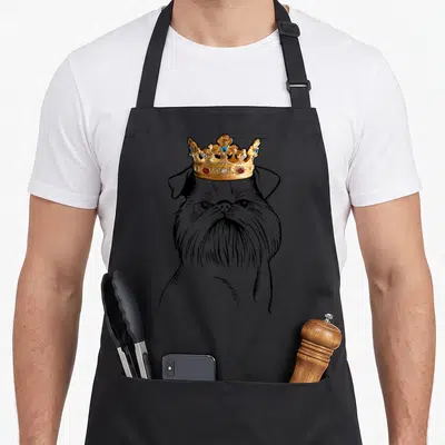 Brussel dog wearing apron - Line art Brussels Griffon head with a jeweled gold crown — shown on a black cotton canvas apron against a white background