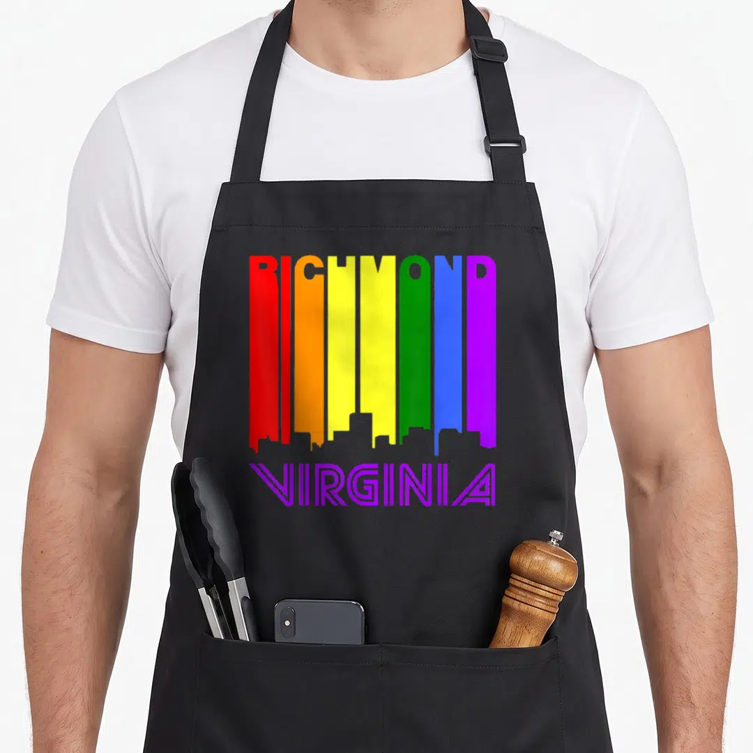 Richmond gay pride apron - RICHMOND rainbow skyline letters with purple VIRGINIA text below — shown on a black cotton canvas apron against a white background