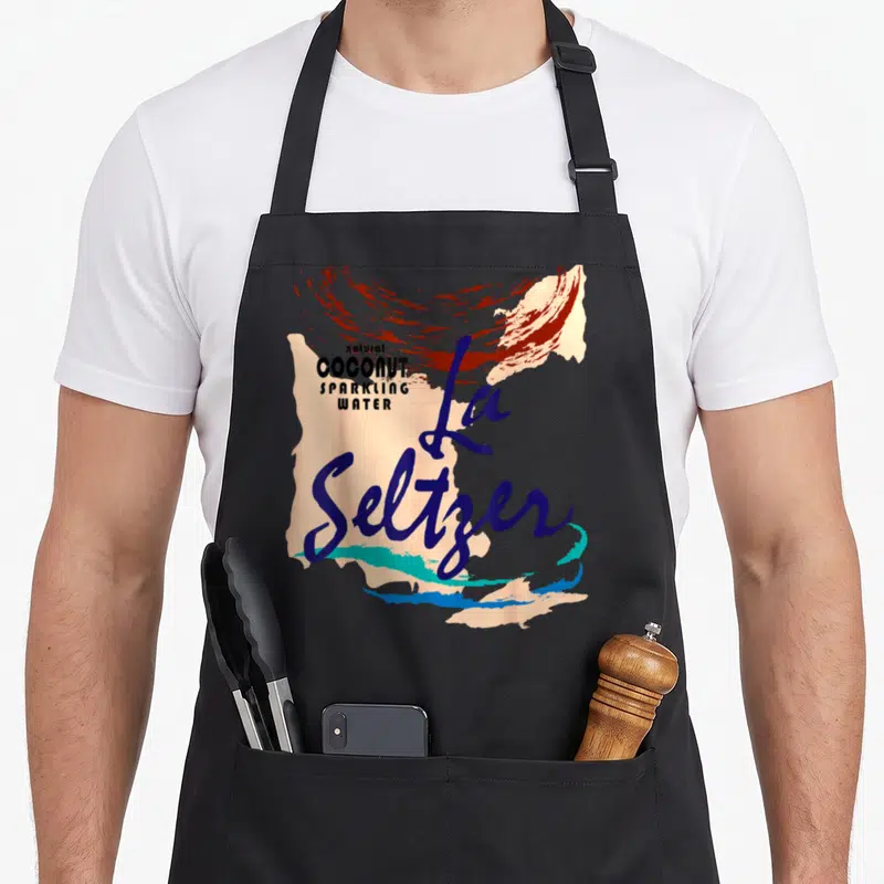 Seltzer halloween apron - La Seltzer script over natural coconut sparkling water text with abstract blue red peach teal — shown on a black cotton canvas apron against a white background