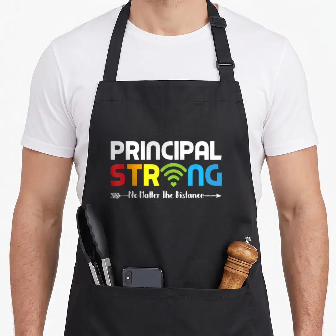 Strong future principal apron - PRINCIPAL STRONG text with wifi symbol and arrow containing No Matter The Distance — shown on a black cotton canvas apron against a white background