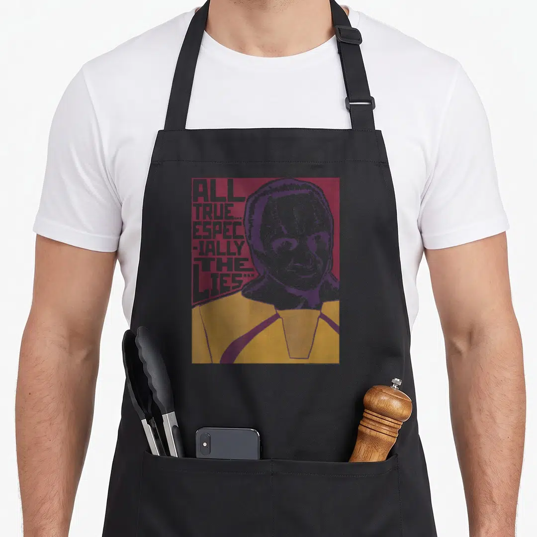 Space novelty apron - Retro portrait of a man with facial ridges next to stacked text on maroon background — shown on a black cotton canvas apron against a white background