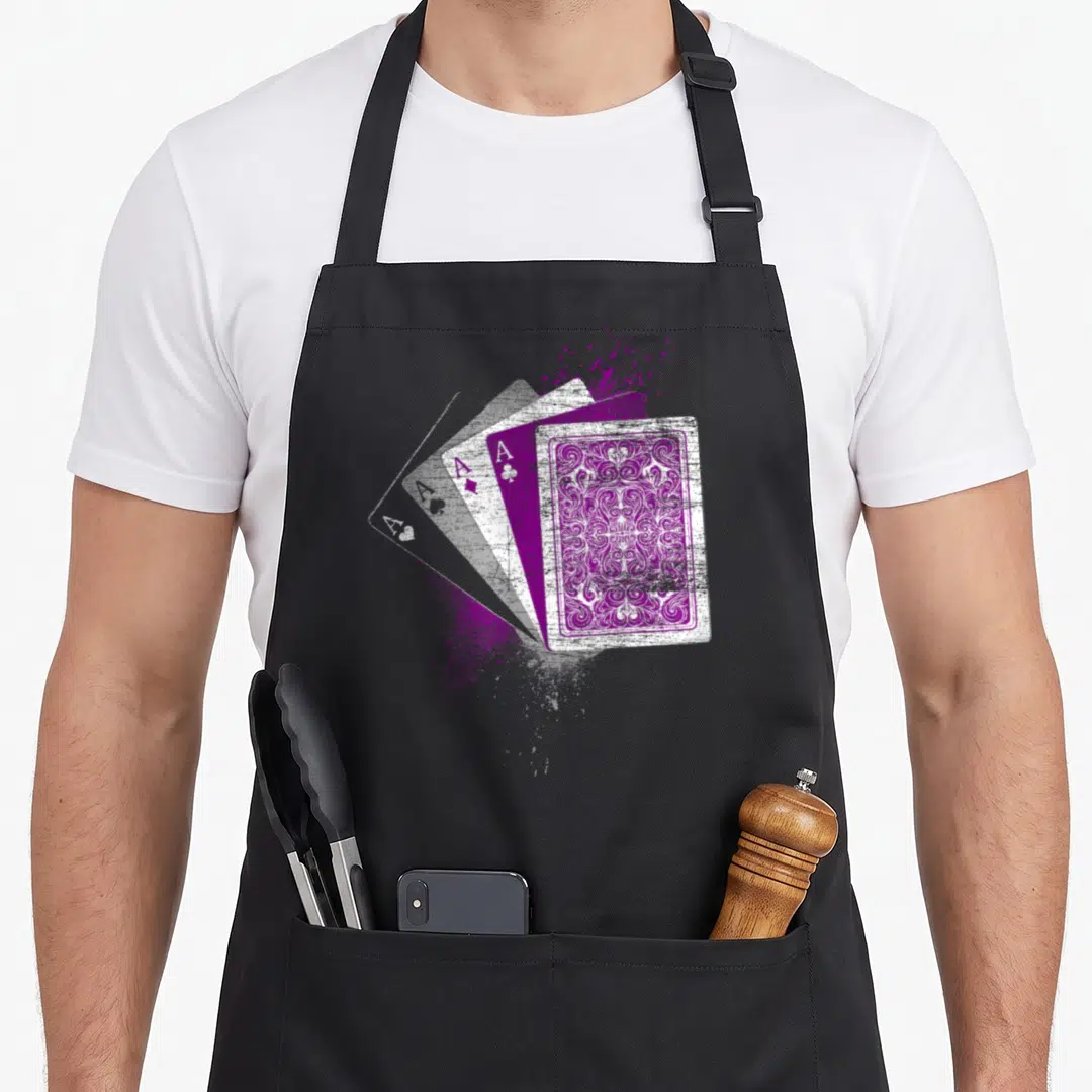 Asexuality ace apron - Four fanned aces with purple paint splatter and distressed texture — shown on a black cotton canvas apron against a white background