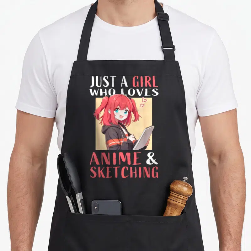 Anime sketching japan apron - Pink hair anime girl holding sketchbook surrounded by Just A Girl Who Loves Anime & — shown on a black cotton canvas apron against a white background