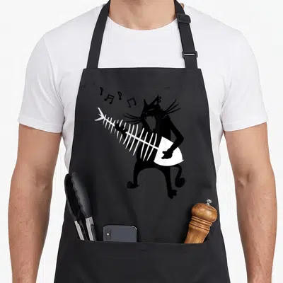 Playing christmas cat apron - Black cartoon cat playing white fishbone guitar with floating musical notes — shown on a black cotton canvas apron against a white background