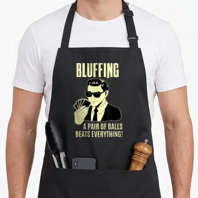 Card texas apron - Cartoon man in sunglasses holding cards with bluffing text — shown on a black cotton canvas apron against a white background