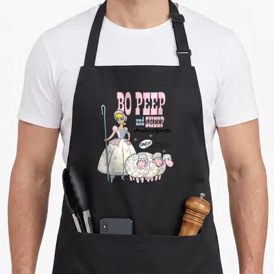 Collection sheep apron - Bo Peep holding crook with three sheep and text BO PEEP and SHEEP Porcelain Figure Set — shown on a black cotton canvas apron against a white background