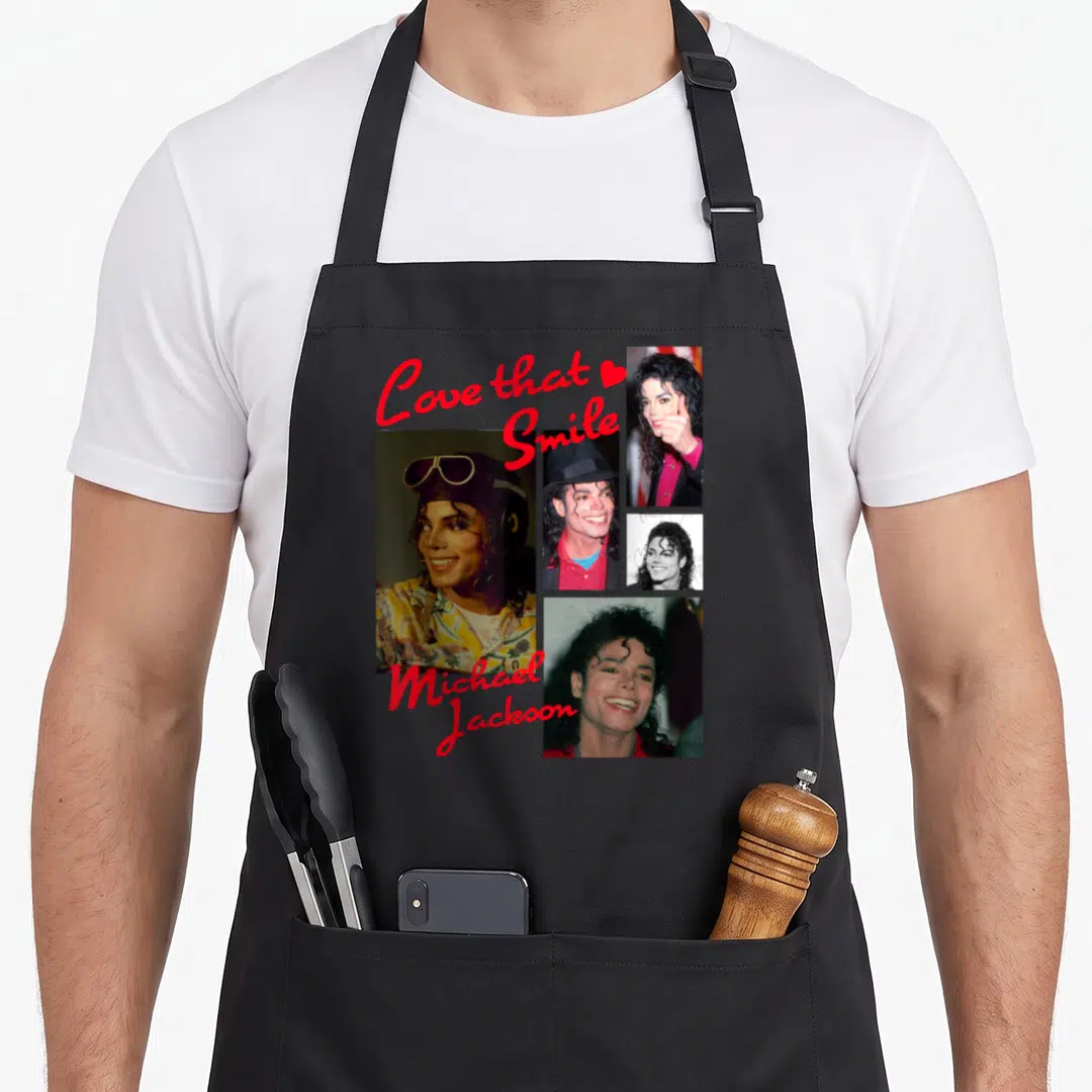 State michaels apron - Collage of four Michael Jackson photos with red Love that Smile text — shown on a black cotton canvas apron against a white background