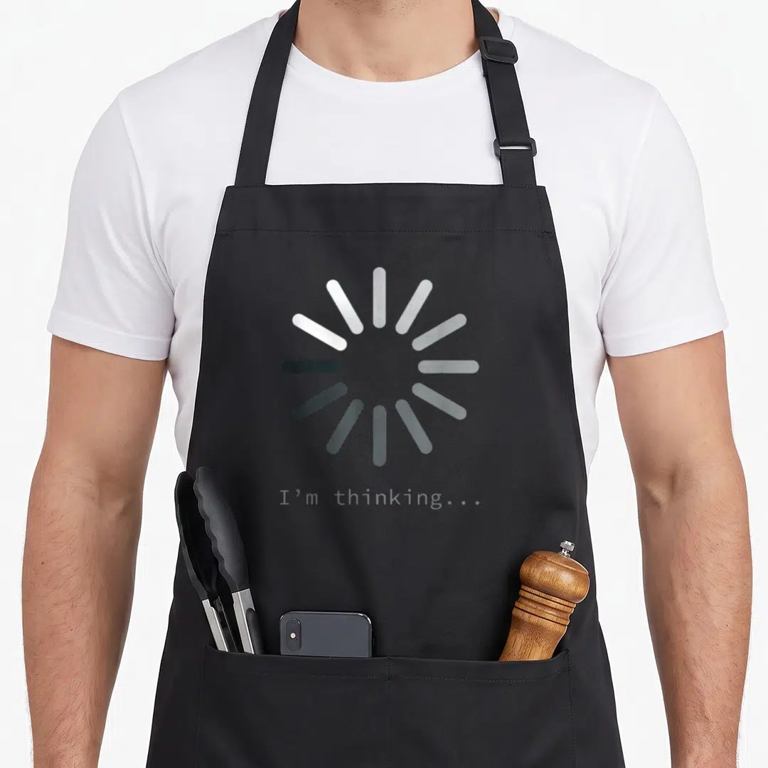 Computer tech nerd apron - Grey circular loading icon with I'm thinking text below — shown on a black cotton canvas apron against a white background