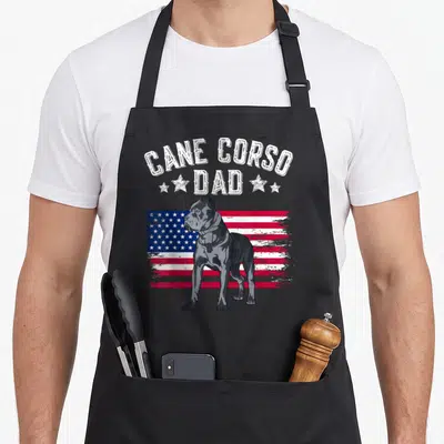 Cane american flag apron - Grey Cane Corso standing before distressed red white and blue flag with arched text — shown on a black cotton canvas apron against a white background