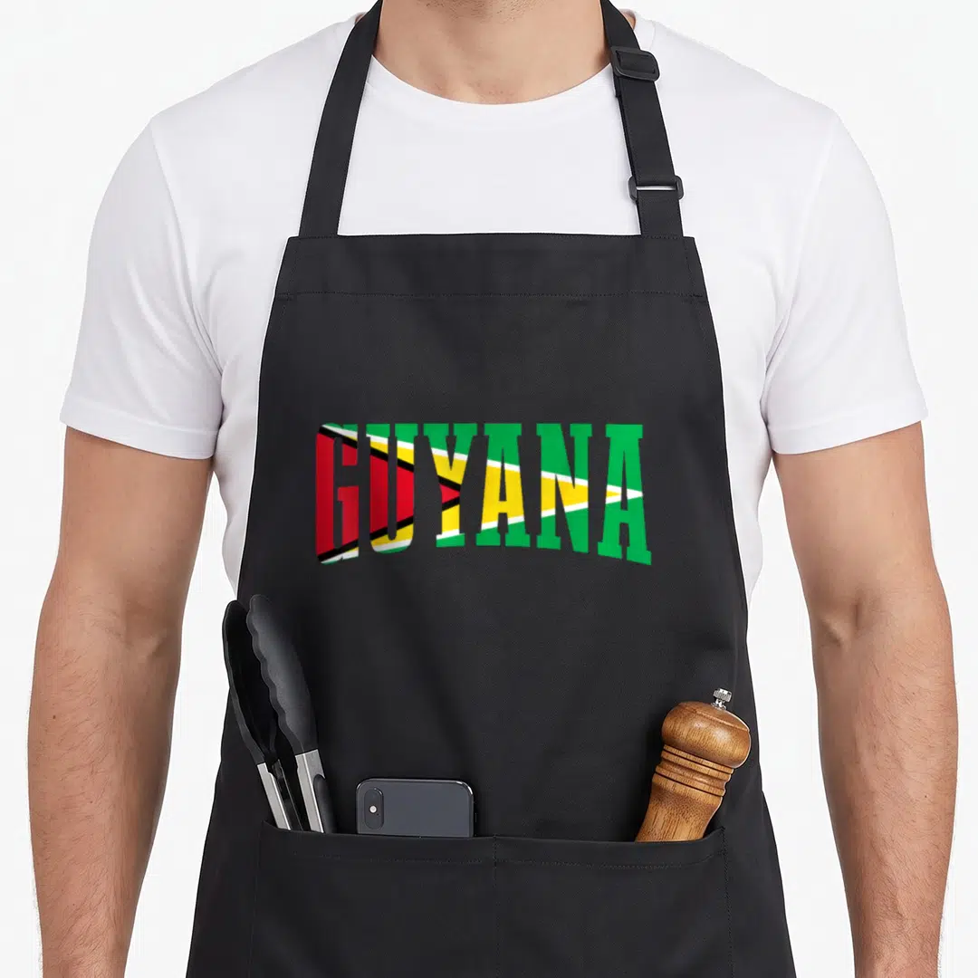 Sport pride apron - GUYANA text filled with green yellow red white and black diagonal flag pattern — shown on a black cotton canvas apron against a white background