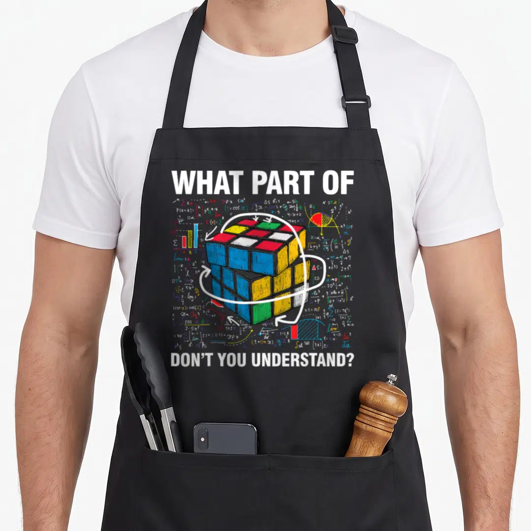 Cubing parts of an apron - Rubik's Cube with math formulas and sarcastic text on grey background — shown on a black cotton canvas apron against a white background