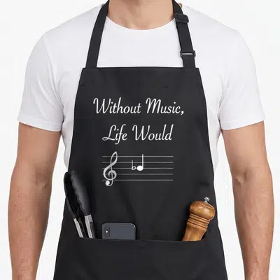 Music flat apron - White text Without Music Life Would above treble clef and flat note on staff — shown on a black cotton canvas apron against a white background