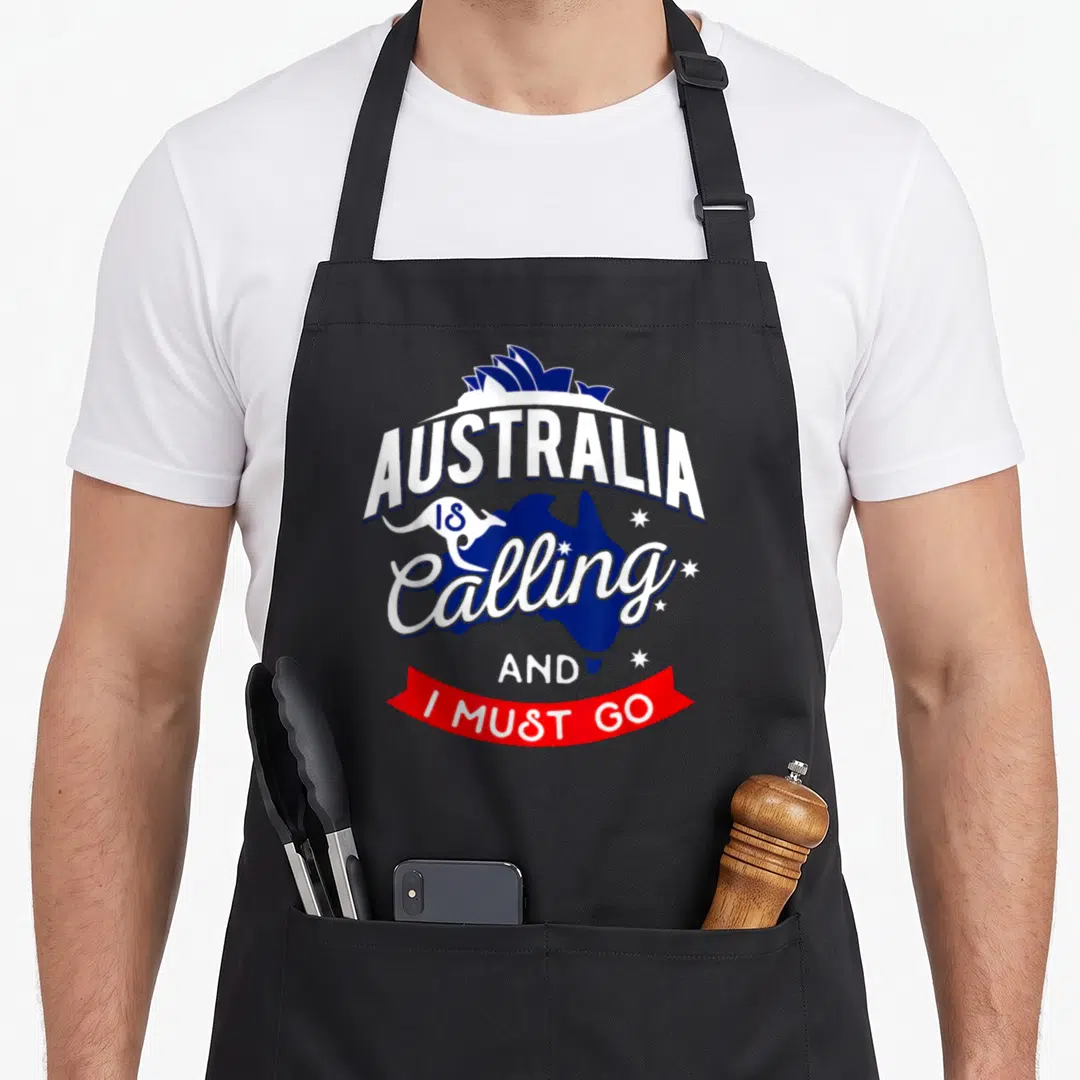 Calling australian apron - Blue Australia map with white text, kangaroo, and red ribbon reading I Must Go — shown on a black cotton canvas apron against a white background