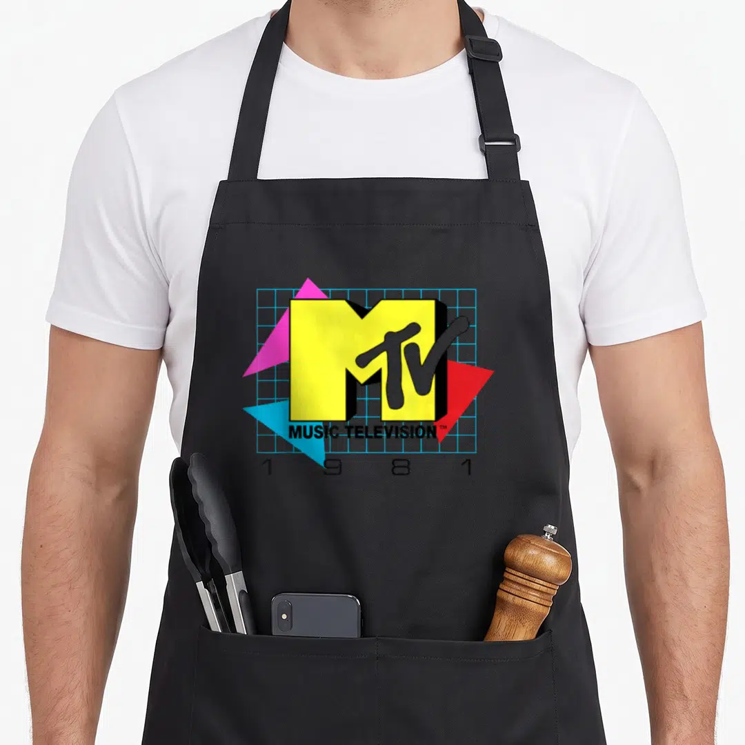 Mtv music apron - Yellow M grey TV logo blue grid three pink red blue triangles 1981 text — shown on a black cotton canvas apron against a white background