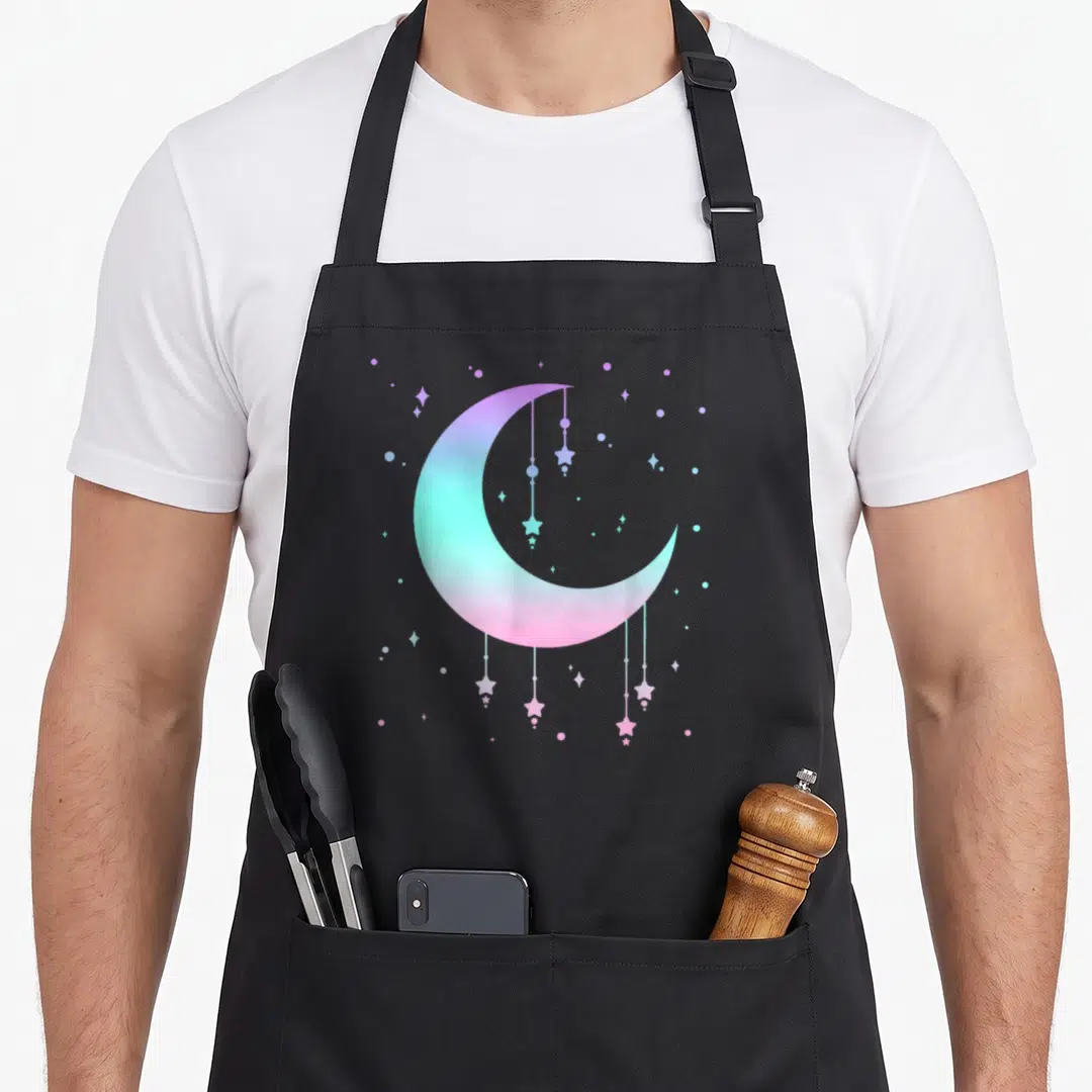 Moon goth apron - Gradient crescent moon with hanging stars and scattered dots in purple, blue, and pink — shown on a black cotton canvas apron against a white background