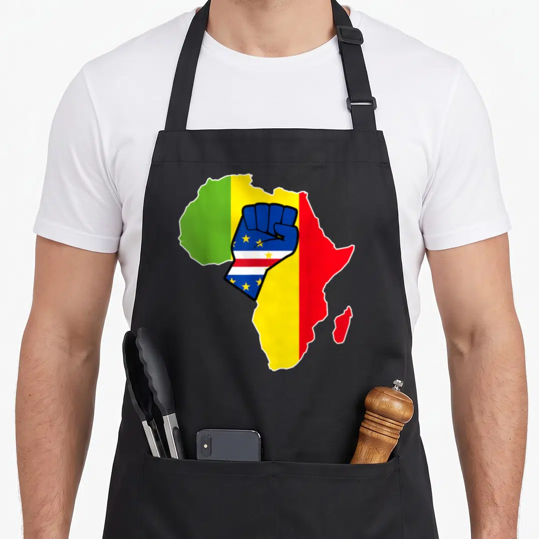 Cape pride apron - Raised fist with stars over Africa map in green yellow red and blue cartoon art — shown on a black cotton canvas apron against a white background