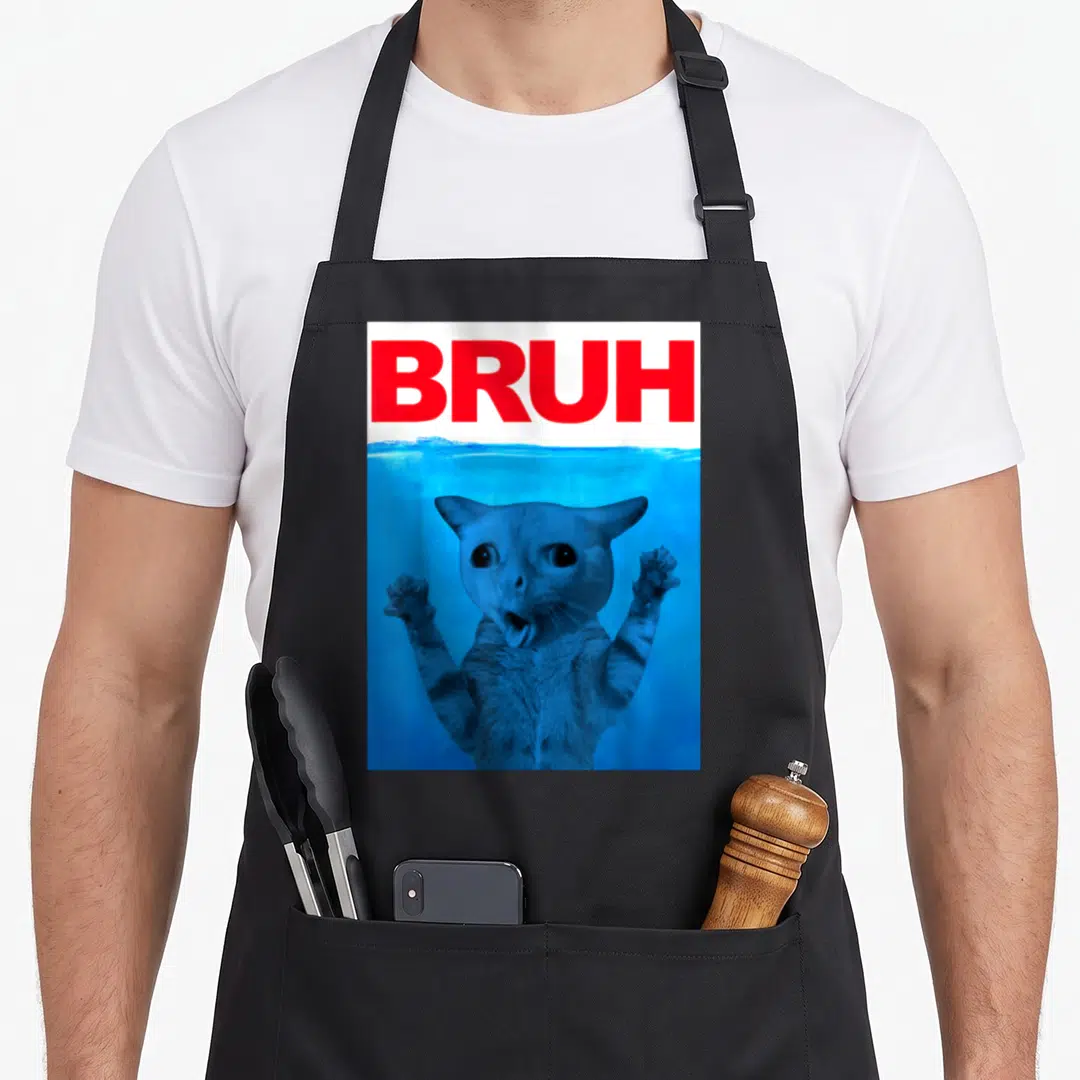 Brother cat apron - Red BRUH text above a blue-tinted photo of a submerged cat with raised paws — shown on a black cotton canvas apron against a white background