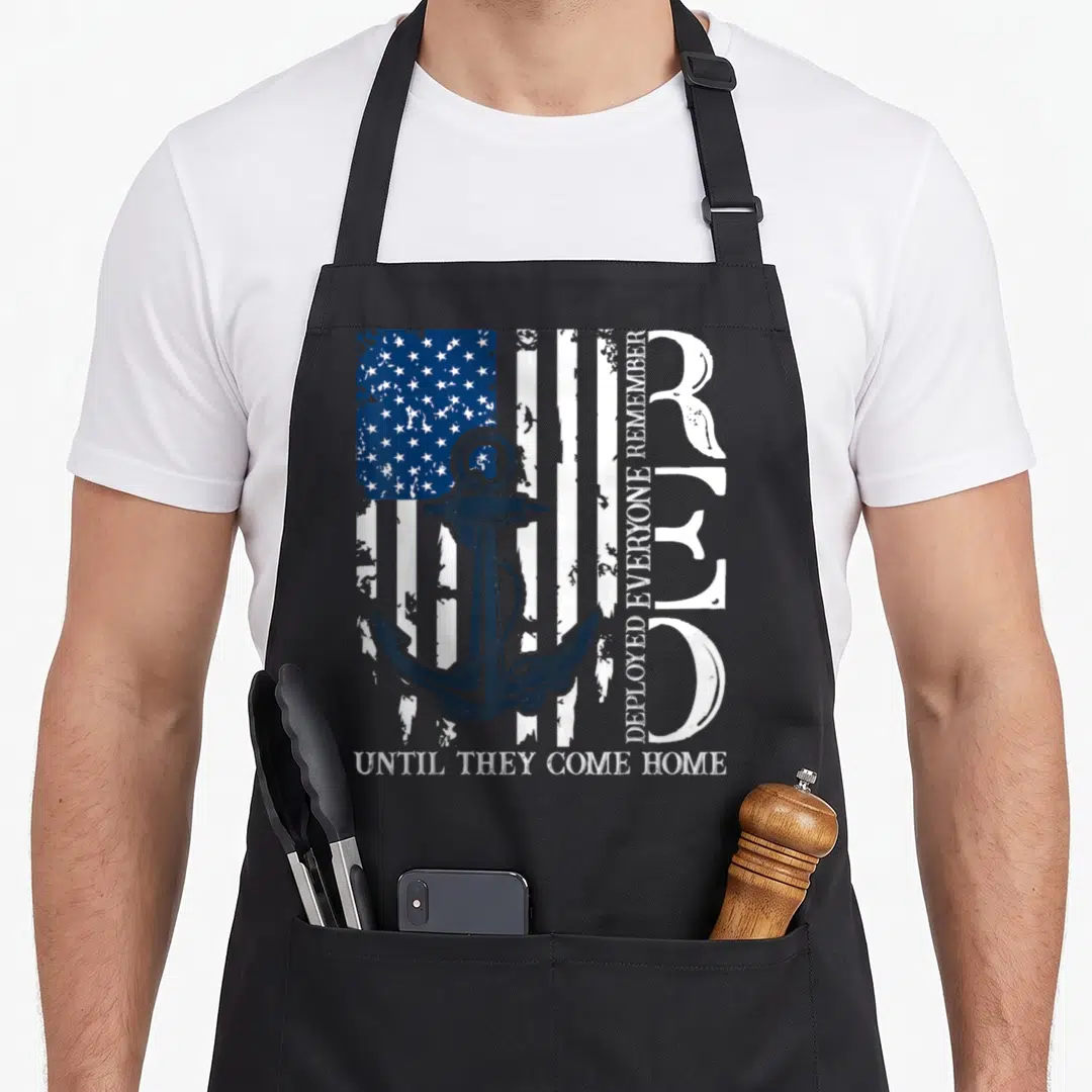 Friday 4th of july apron - Anchor over distressed US flag with vertical and horizontal text reading Remember Deployed — shown on a black cotton canvas apron against a white background