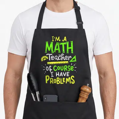 Class teacher apron - Stacked text I'M A MATH Teacher with protractor triangle ruler and straight ruler in lime green — shown on a black cotton canvas apron against a white background