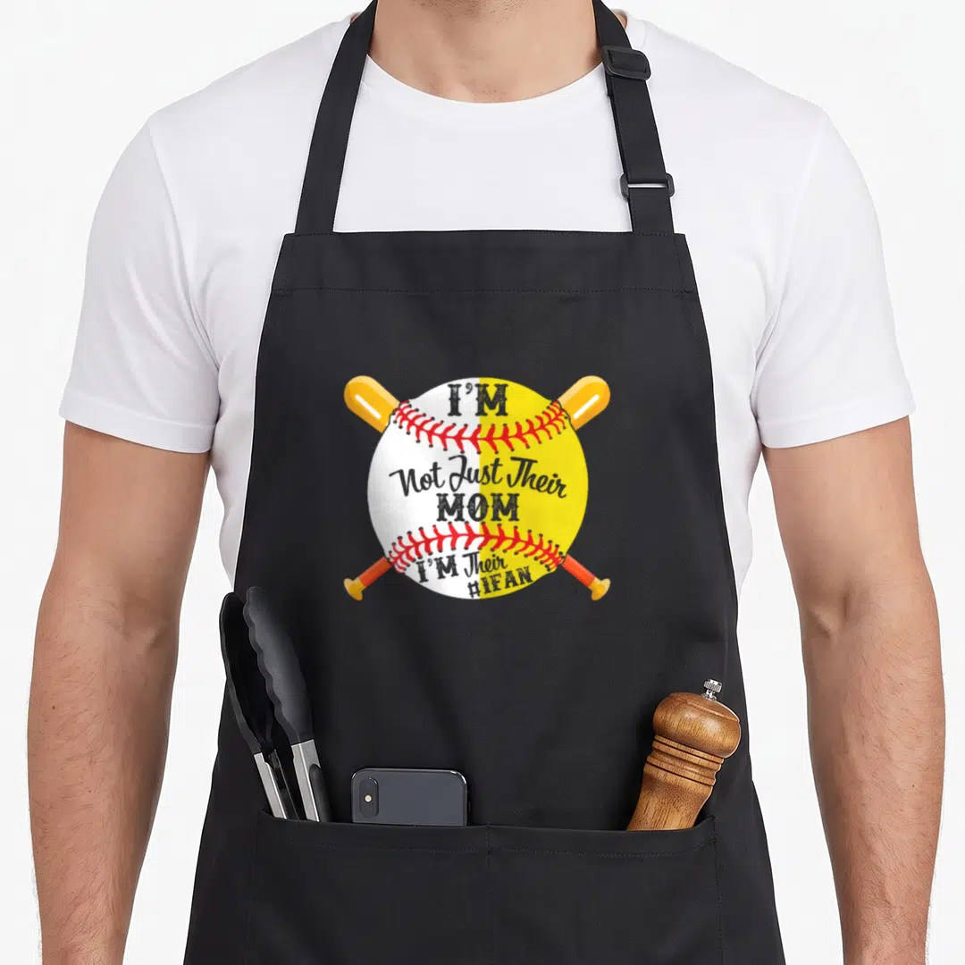 Their baseball apron - Crossed orange and yellow bats behind a split white and yellow baseball with red stitching — shown on a black cotton canvas apron against a white background
