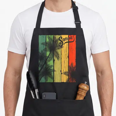 Samoa tree apron - Samba text over grey palm trees on five green yellow orange red stripes — shown on a black cotton canvas apron against a white background