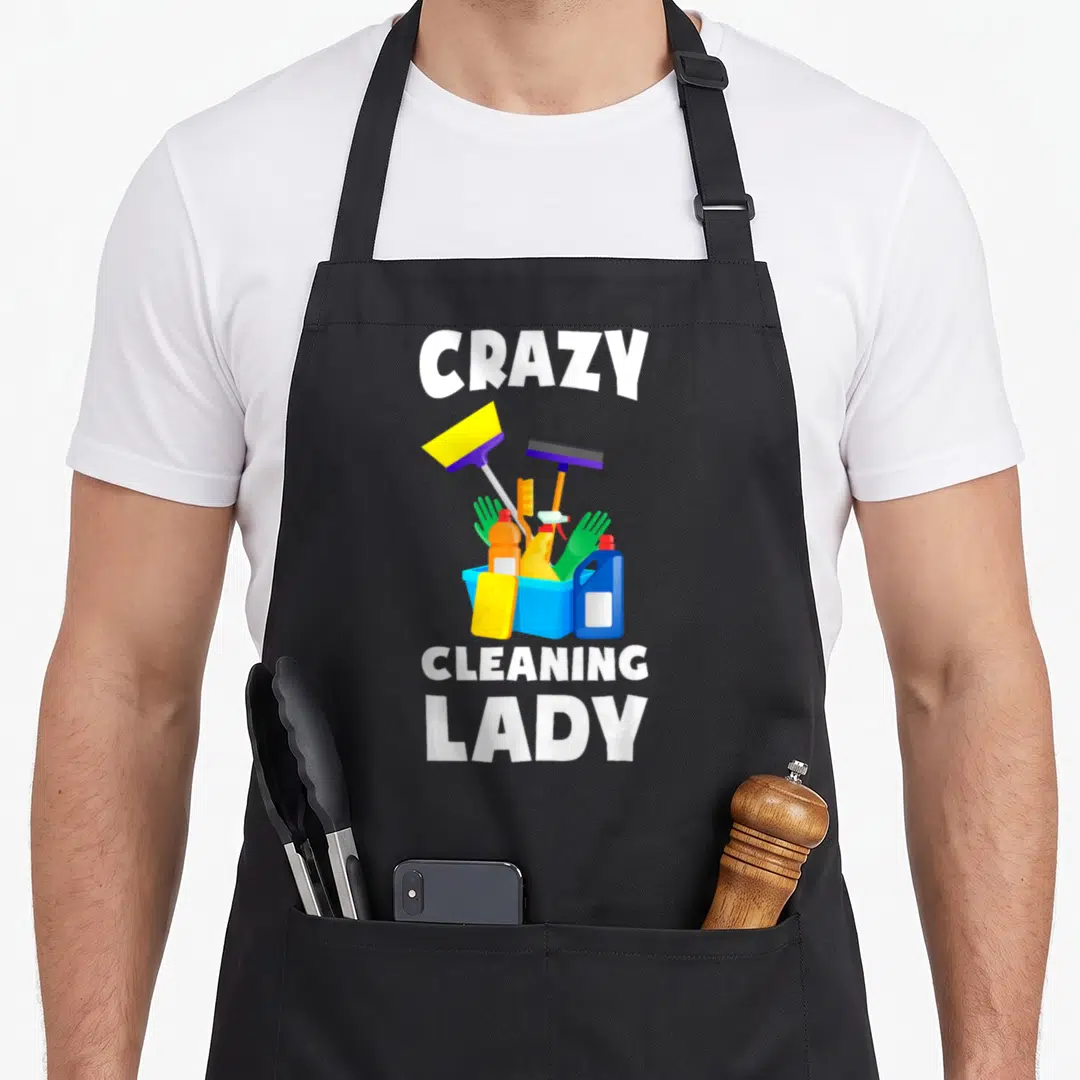 Retro cleaning housekeeper apron - CRAZY CLEANING LADY text above a blue bucket filled with broom, squeegee, gloves — shown on a black cotton canvas apron against a white background
