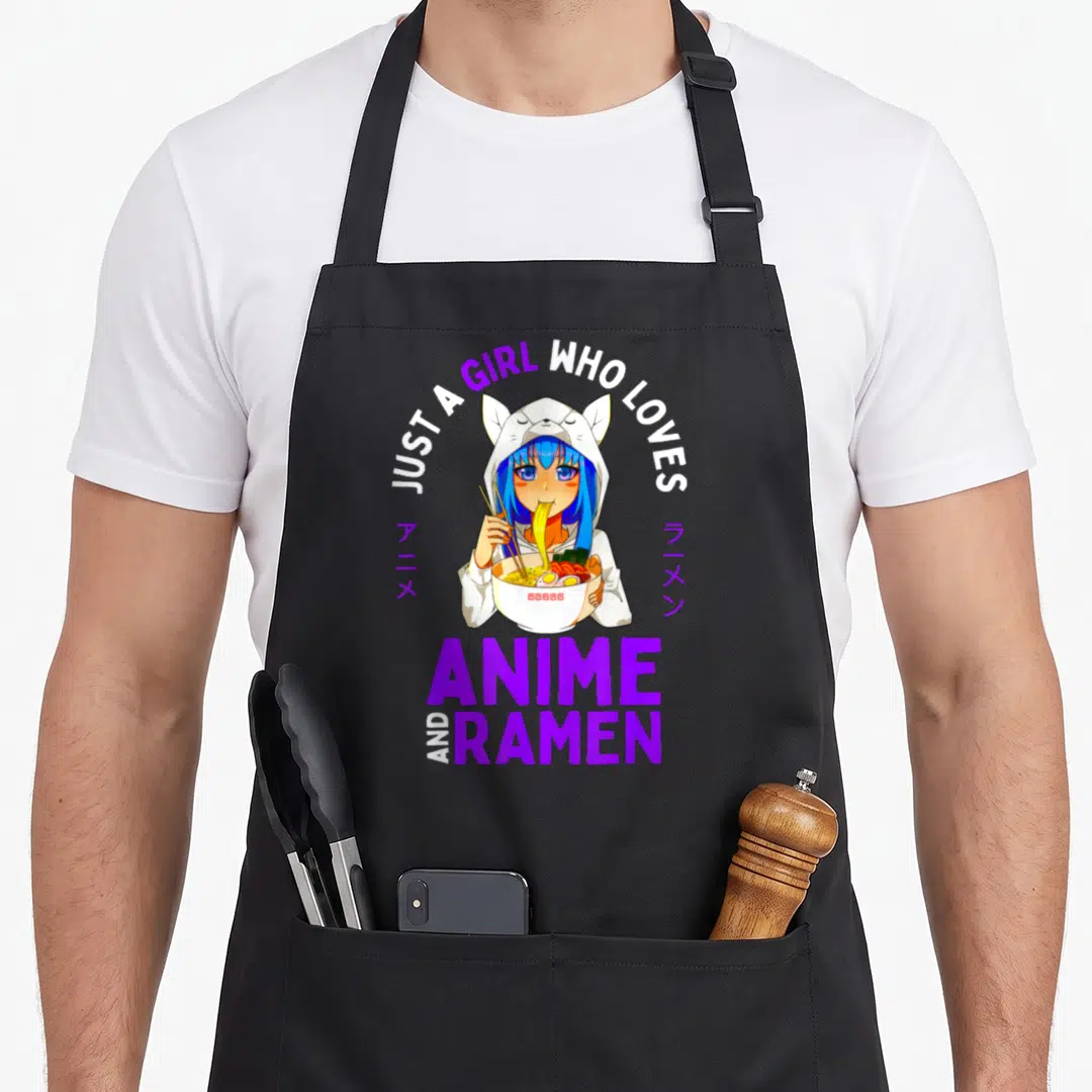 Anime japan apron - Anime girl in cat hoodie holding ramen bowl with purple and white text — shown on a black cotton canvas apron against a white background