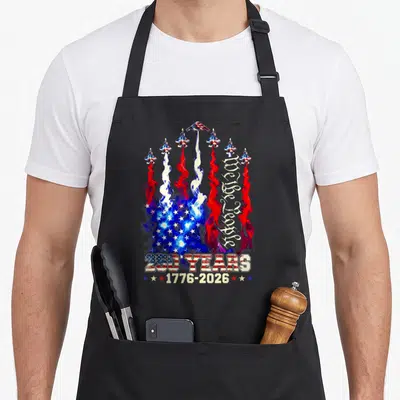 250th anniversary flag 4th of july apron - Seven jets leaving red white and blue smoke trails forming a flag pattern — shown on a black cotton canvas apron against a white background