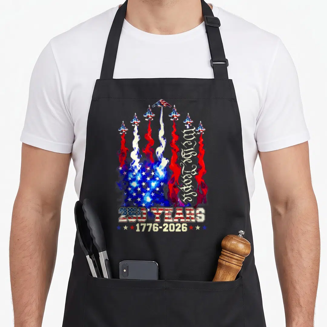 250th anniversary flag 4th of july apron - Seven jets leaving red white and blue smoke trails forming a flag pattern — shown on a black cotton canvas apron against a white background