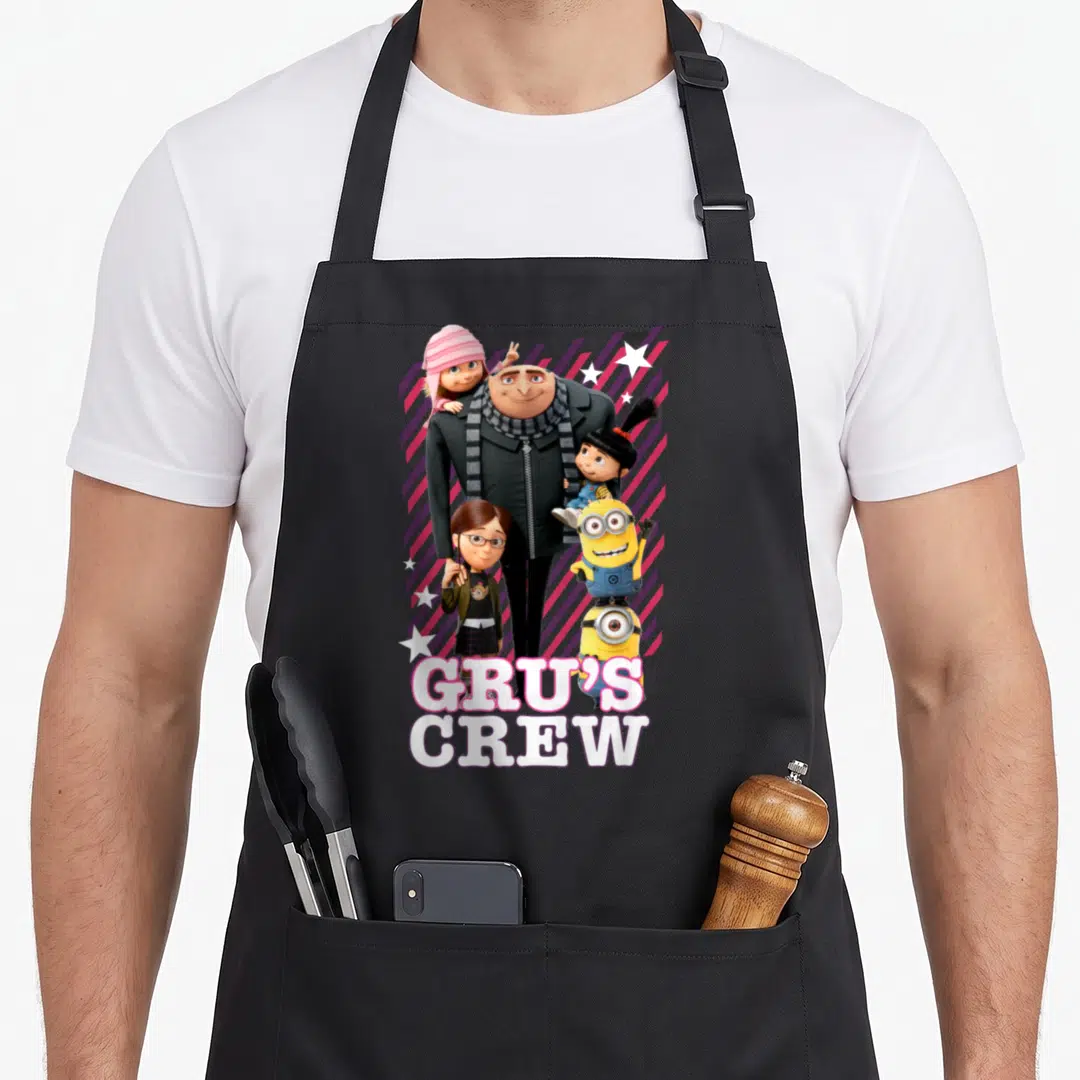 Despicable crew apron - Gru and three girls with two Minions over purple stripes and stars — shown on a black cotton canvas apron against a white background