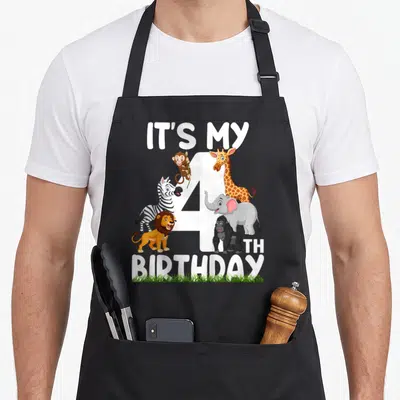 4th zoo birthday apron - Cartoon giraffe elephant zebra lion gorilla monkey around white number 4 with IT'S MY 4TH — shown on a black cotton canvas apron against a white background