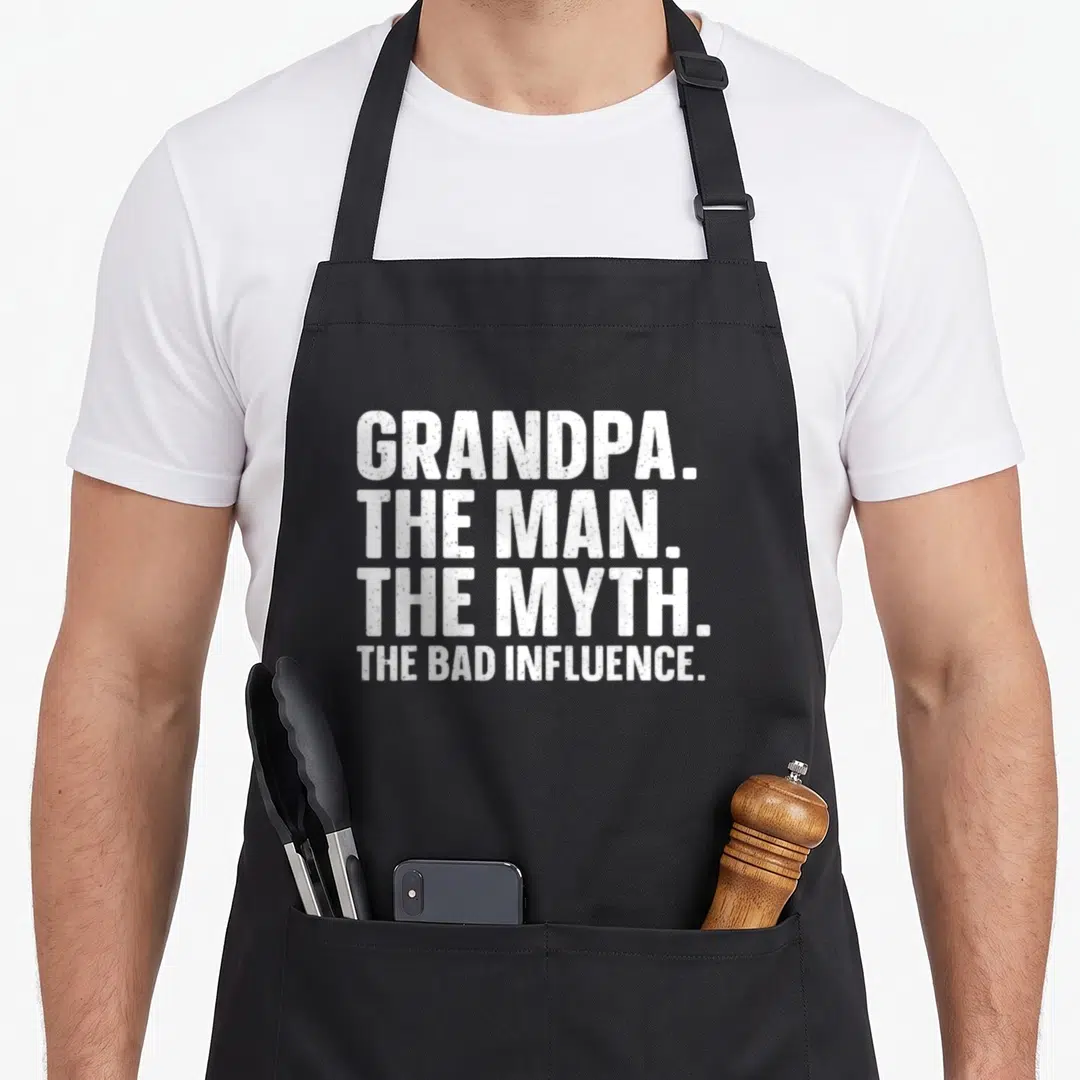 Papa grandparent grandpa apron - White stacked text GRANDPA THE MAN THE MYTH THE BAD INFLUENCE — shown on a black cotton canvas apron against a white background